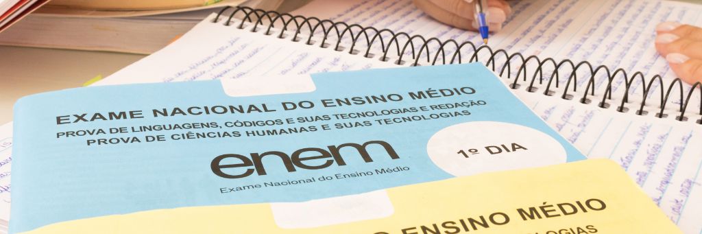 moça estudando com provas do enem
